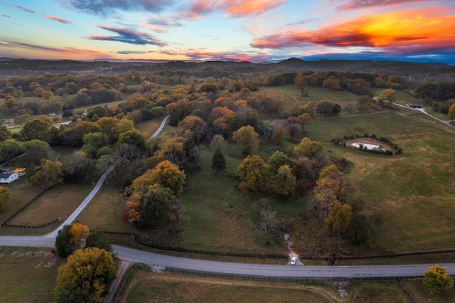 aerial view at dusk featuring a mountain view