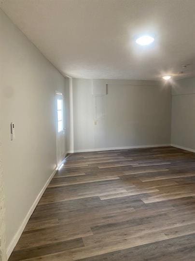 unfurnished room featuring dark wood-type flooring