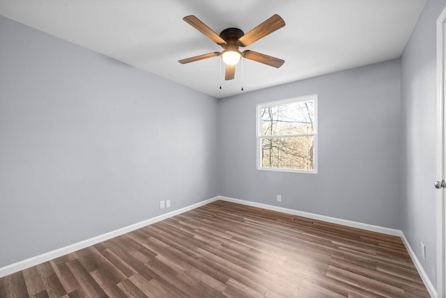 unfurnished room featuring ceiling fan and dark wood-type flooring