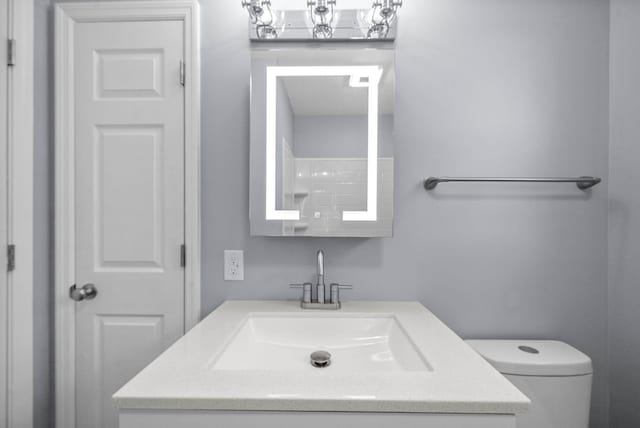 bathroom featuring toilet and vanity