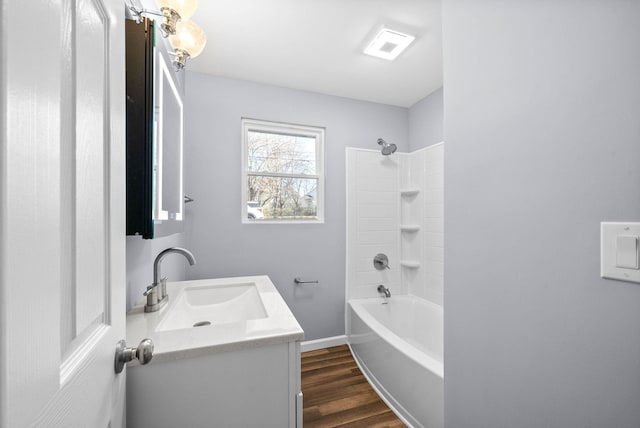 bathroom with shower / bathtub combination, hardwood / wood-style flooring, and vanity