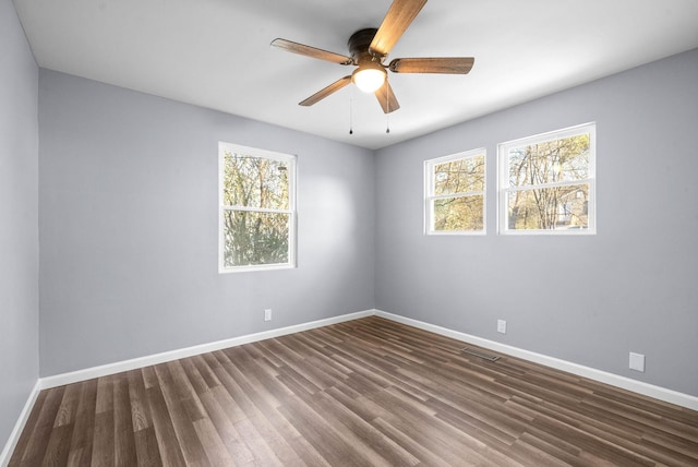 empty room featuring ceiling fan and dark hardwood / wood-style floors