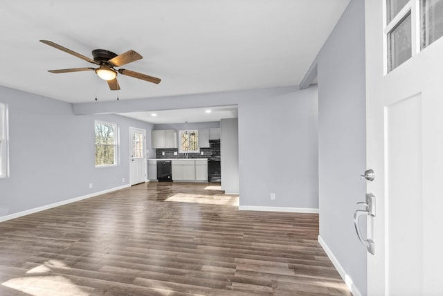 unfurnished living room with ceiling fan and dark hardwood / wood-style floors