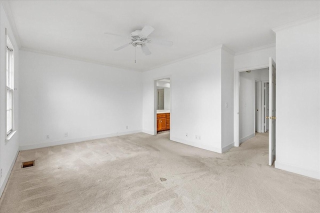 carpeted empty room with ceiling fan and ornamental molding