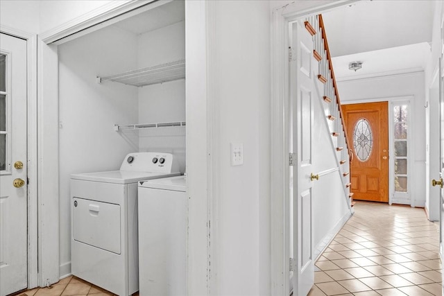 laundry room featuring washer and dryer and light tile patterned flooring