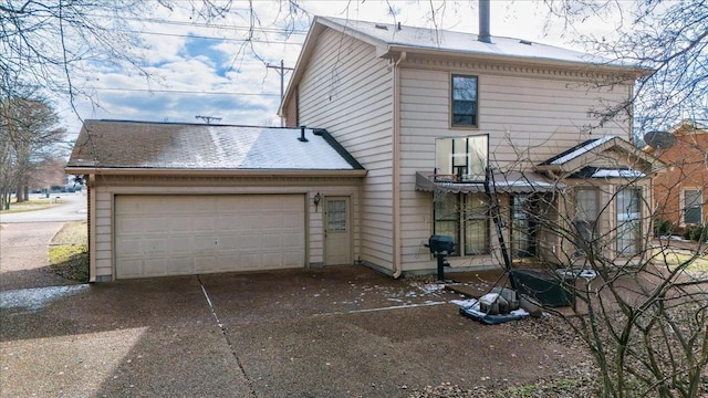 back of property with a garage