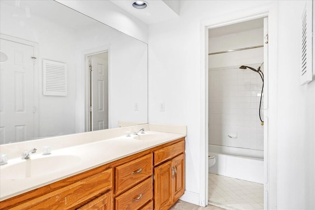 full bathroom featuring toilet, vanity, and tiled shower / bath combo