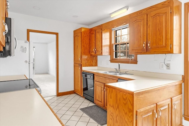 kitchen featuring black dishwasher, sink, refrigerator, light tile patterned floors, and stove