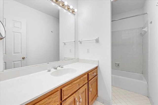 bathroom with vanity, tile patterned flooring, and tiled shower / bath