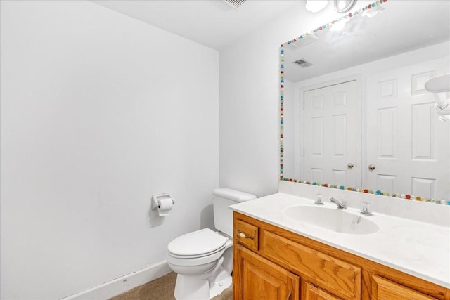 bathroom featuring toilet and vanity