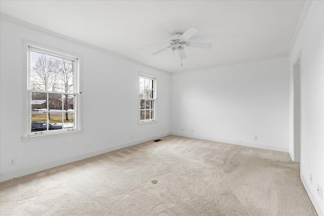 empty room with light carpet, ceiling fan, and crown molding