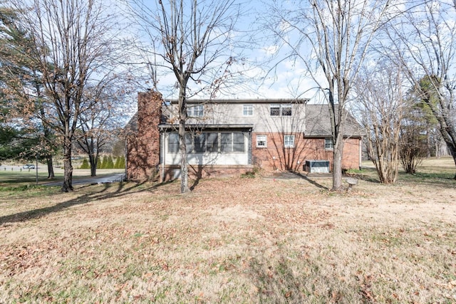 back of house featuring a yard