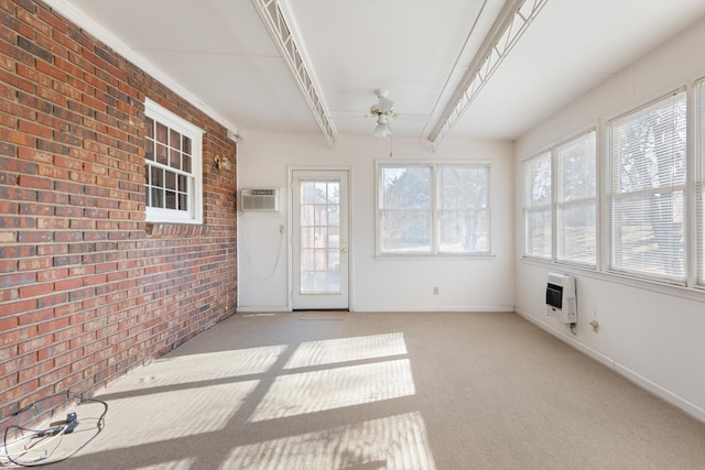 unfurnished sunroom featuring ceiling fan, heating unit, beamed ceiling, and a wall mounted air conditioner