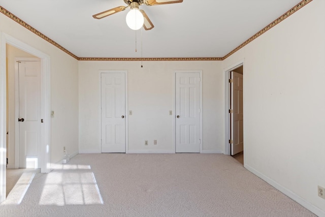 unfurnished bedroom featuring ceiling fan and light colored carpet