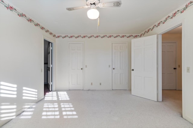 unfurnished bedroom with light carpet and ceiling fan