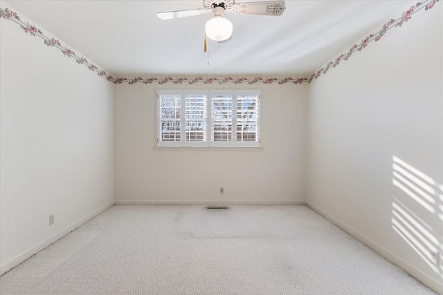 carpeted empty room featuring ceiling fan