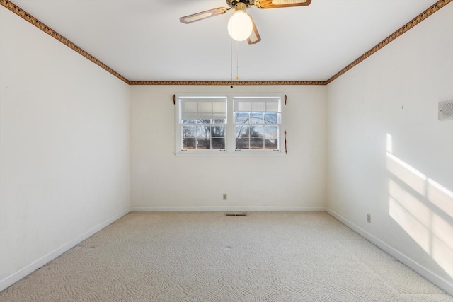 empty room featuring ceiling fan and light carpet