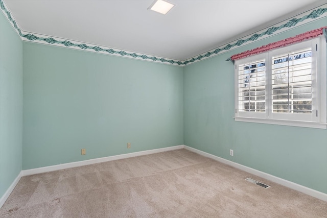 spare room with light colored carpet