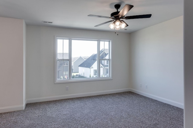 carpeted empty room featuring ceiling fan