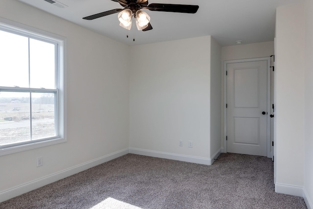 carpeted empty room featuring ceiling fan