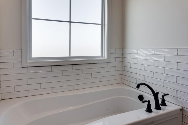 bathroom featuring a tub to relax in