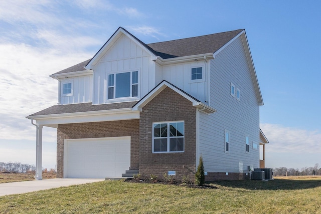 view of front facade featuring a front lawn, a garage, and central air condition unit