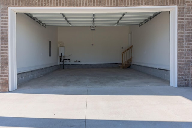 garage featuring a carport, water heater, and a garage door opener