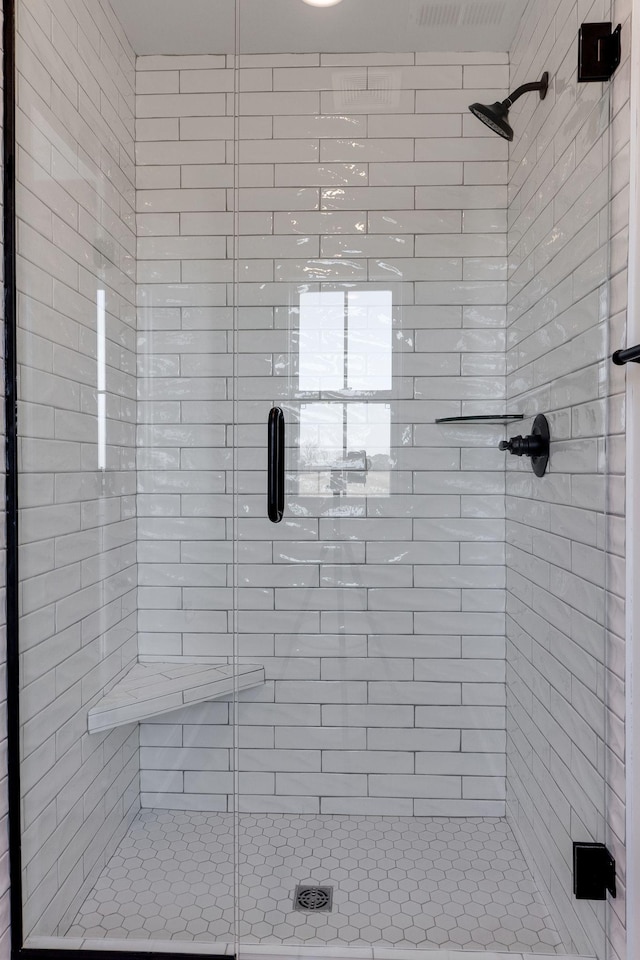 bathroom with a shower with door