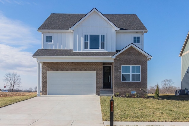 view of front facade with a garage, a front yard, and cooling unit