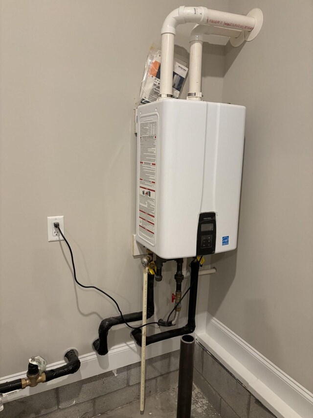 utility room featuring tankless water heater