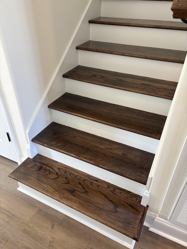 stairway with hardwood / wood-style floors