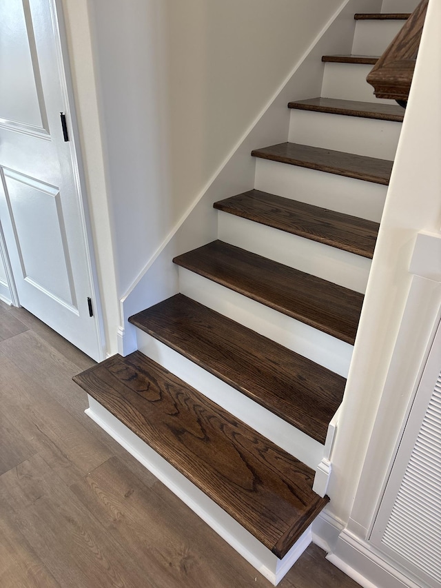 stairs with hardwood / wood-style floors