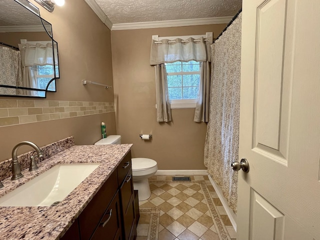 bathroom with toilet, vanity, tile patterned flooring, a textured ceiling, and ornamental molding