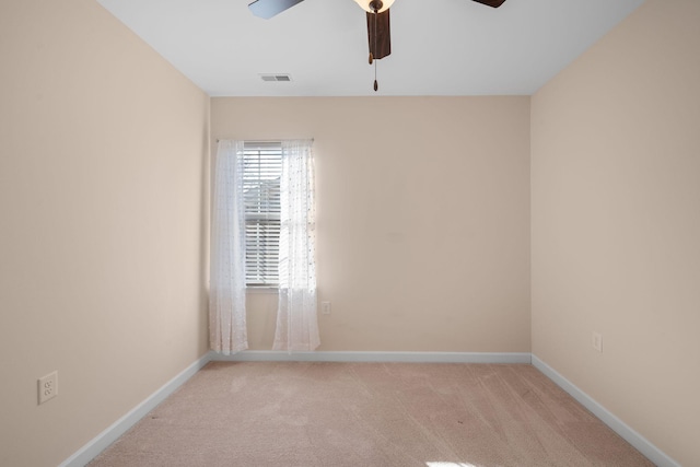 carpeted empty room featuring ceiling fan