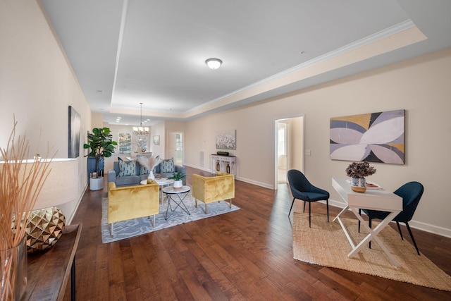 living room with ornamental molding, a raised ceiling, an inviting chandelier, and dark hardwood / wood-style flooring