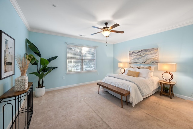 carpeted bedroom with ceiling fan and ornamental molding