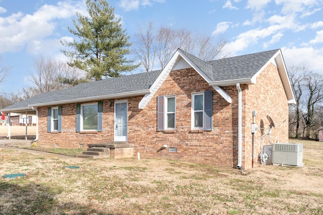 view of front of home with central air condition unit and a front lawn