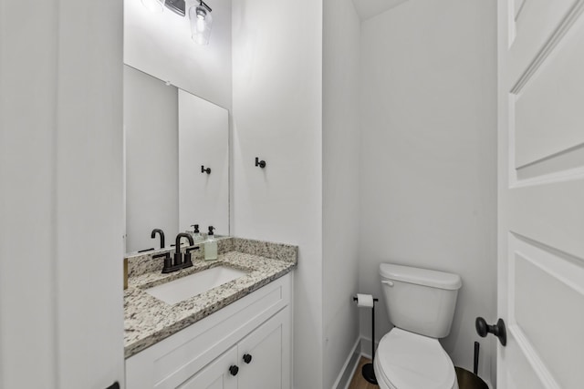 bathroom featuring toilet and vanity