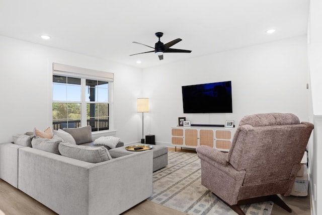 living room with ceiling fan and light hardwood / wood-style floors