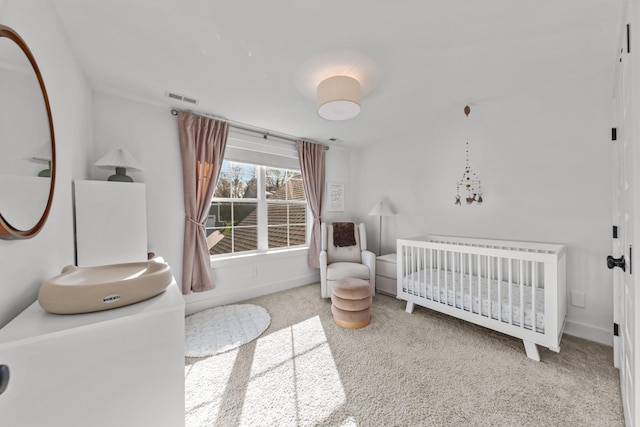 bedroom featuring carpet and a nursery area