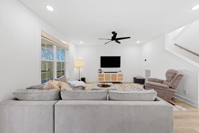 living room with ceiling fan and light hardwood / wood-style floors