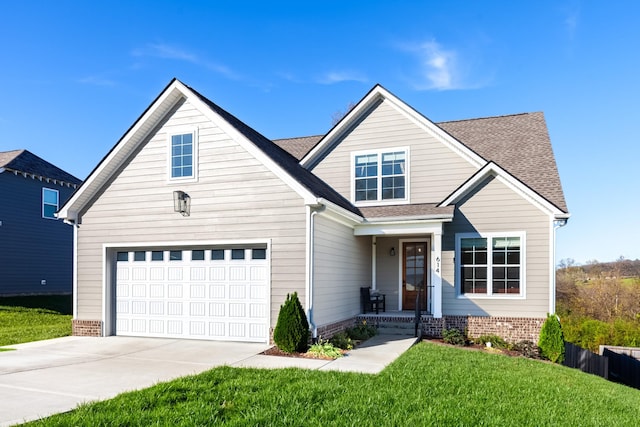 view of front of home with a front yard and a garage