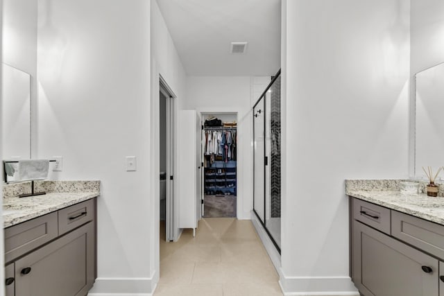 bathroom featuring an enclosed shower and vanity