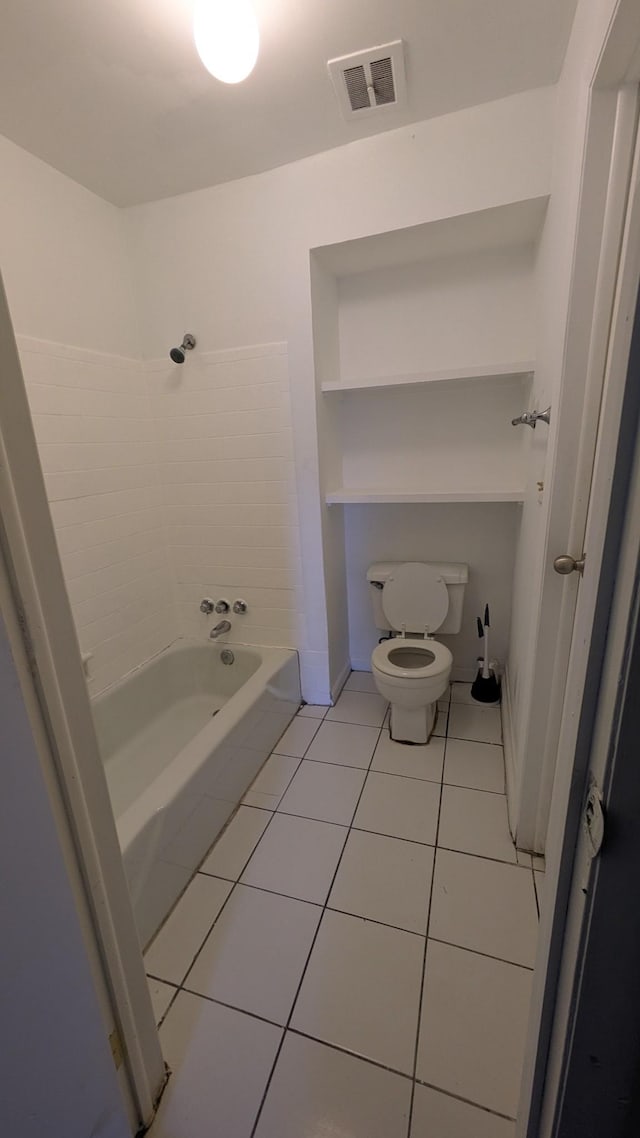 bathroom with toilet, shower / bathtub combination, and tile patterned flooring