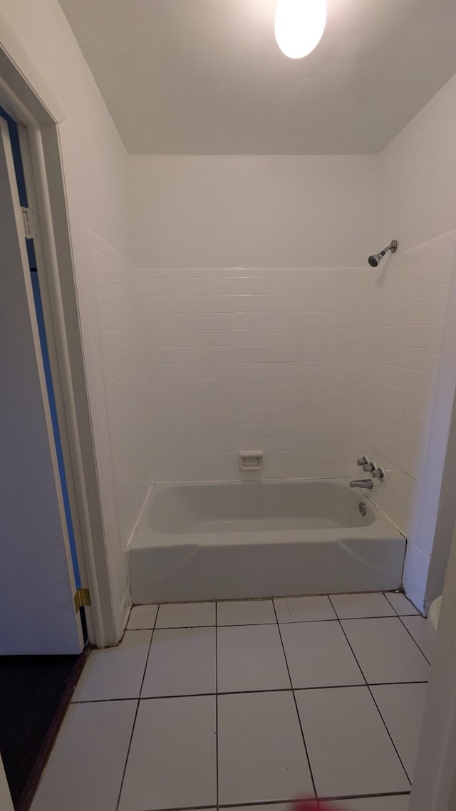 bathroom with washtub / shower combination and tile patterned flooring