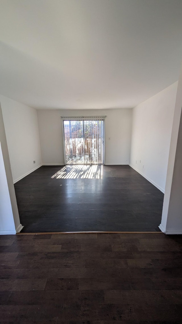 unfurnished room featuring dark hardwood / wood-style floors