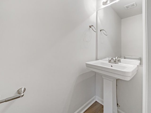 bathroom with hardwood / wood-style floors