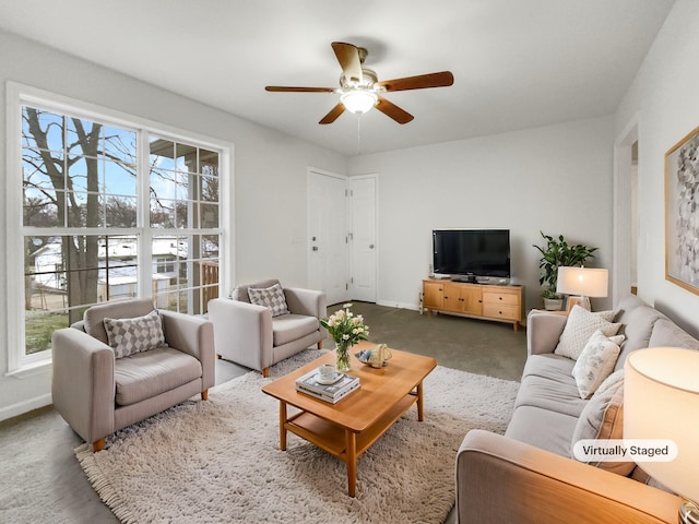 living room featuring ceiling fan, plenty of natural light, and carpet flooring