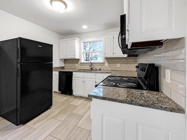 kitchen featuring black appliances, decorative backsplash, sink, white cabinetry, and dark stone counters