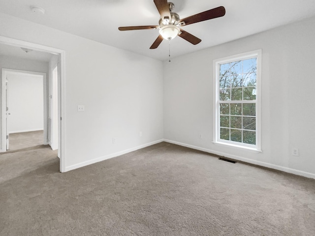 carpeted empty room featuring ceiling fan